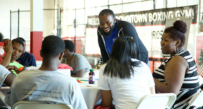 Alonzo Warren works with Service Scholars at a ServiceWorks Bootcamp in Detroit.