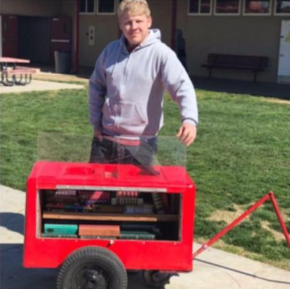 Zachery Ramos pictured with his Traveling Library cart./Courtesy Zachery Ramos