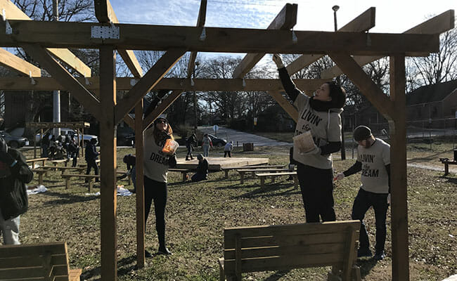 MLK Day 2018 volunteers stain a structure at a public space in Atlanta's English Avenue neighborhood, where several community revitalization projects are underway.
