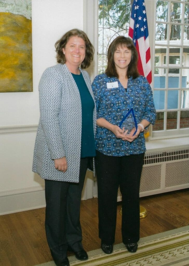 Amber Martin-Jahn (left), executive director of Serve Washington, presents Sally Halela the 2018 Governor’s Volunteer Service Award./Courtesy Sally Halela