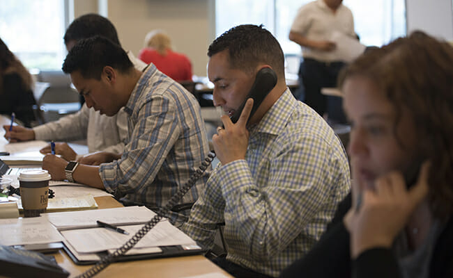 Employee volunteers from CSAA Insurance Group make wellness calls to community members affected by the California wildfires.
