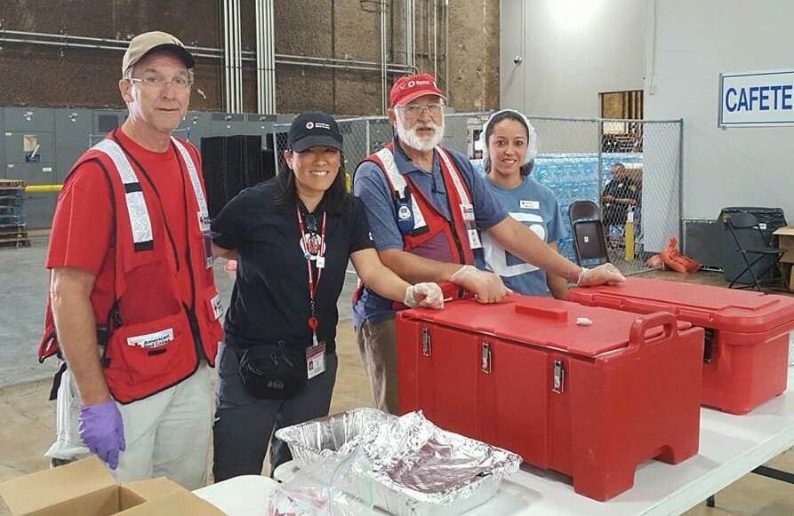Vivian Moy pictured alongside the Red Cross feeding crew inside of a mega shelter in San Antonio, Texas during Hurricane Harvey.  The team served hot meals to those displaced as a result of the hurricane./Courtesy Vivian Moy