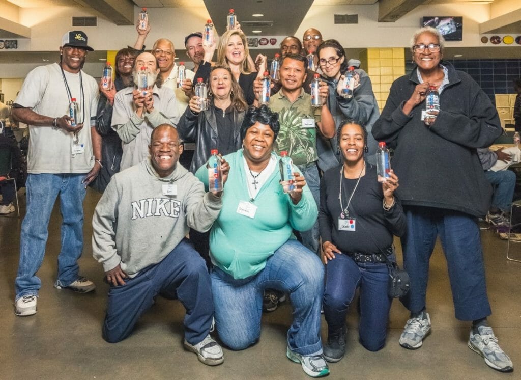 Elena Davis (back row, center) with clients of The Beacon, a nonprofit serving the homeless community in Houston and Harris County, Texas.