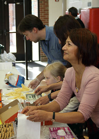 Dr. Kiran Frey and Chess Without Borders volunteers participate in a fundraiser organized by the club.