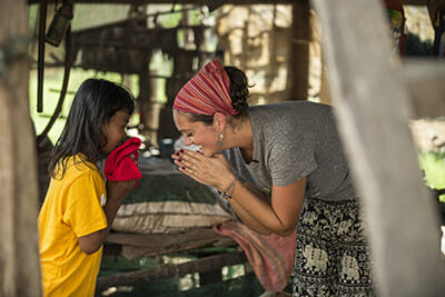 Mallory Brown visiting orphans while in Cambodia.