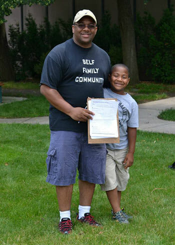 Norman Hurns and a camper participating in voter registration drive.