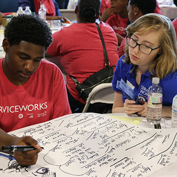 AmeriCorps Vista member Anjie Diaz working with ServiceWorks Scholar