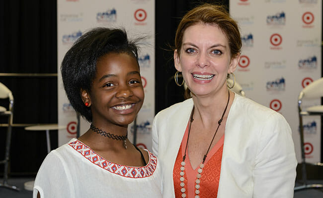 Points of Light CEO Tracy Hoover and Detroit's youngest entrepreneur Asia Newson (aka Super Business Woman) on stage at the Business Track opening session.