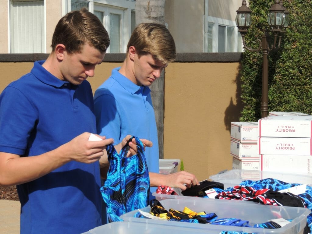 Chris and Matt Hales sorting swimsuit donations.