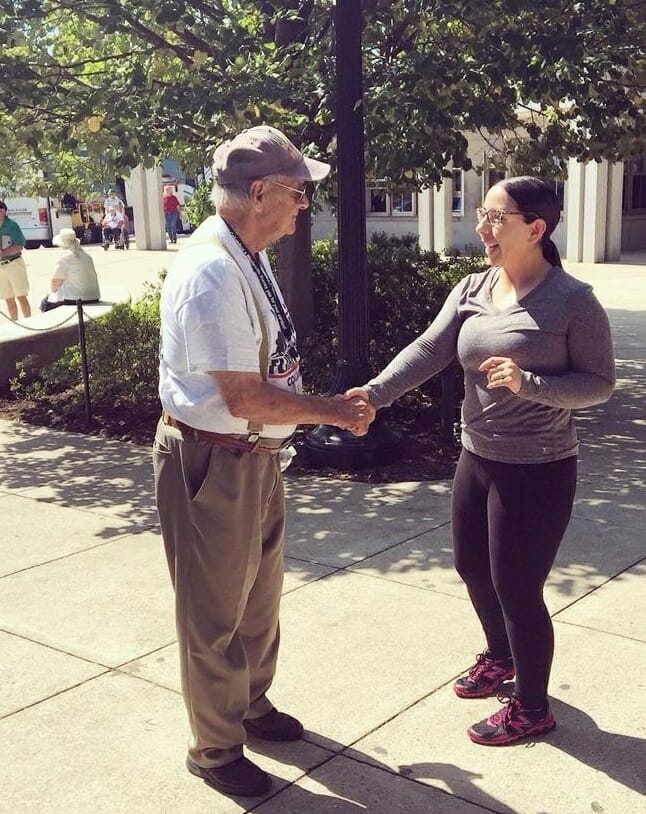 Sullivan greeting an honor flight veteran at the WWII Memorial in DC.