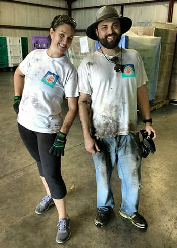 Brittany Chaney (left) and coworker Kyle Trager after completing a service project with Hands On Orlando.