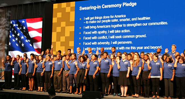 ServiceWorks VISTAs being sworn in on stage during the Opportunity Nation Summit.