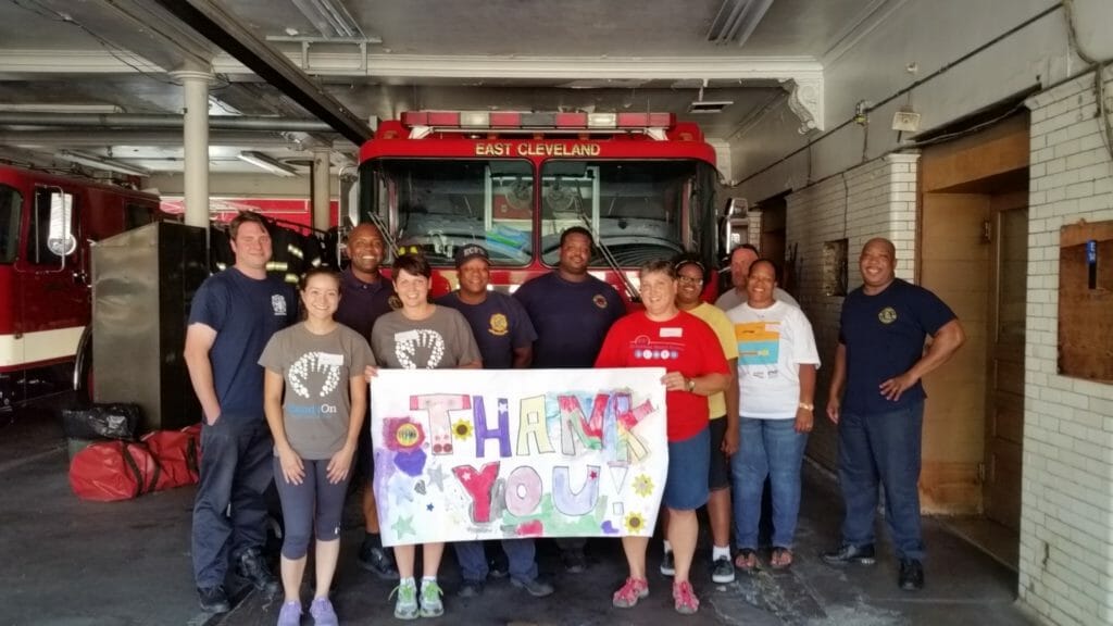 Lynn Hubach (fifth from right) was a volunteer leader at the 9/11 dinner held by HandsOn for the East Cleveland Fire Department./ Courtesy Lynn Hubach