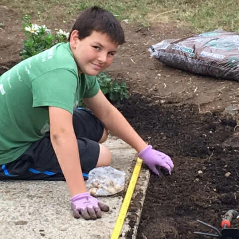 Dylan Martini helped complete an Eagle Scout project, removing 30 large bushes and planting red, white and blue perennials.