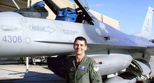 Tim Newton in front of a F-16 fighter aircraft/ Courtesy Tim Newton