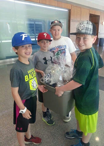 Zach Morgan, Andy Rutecki and their friends delivering Easter baskets to patients at Our Lady of the Lake Children's Hospital.