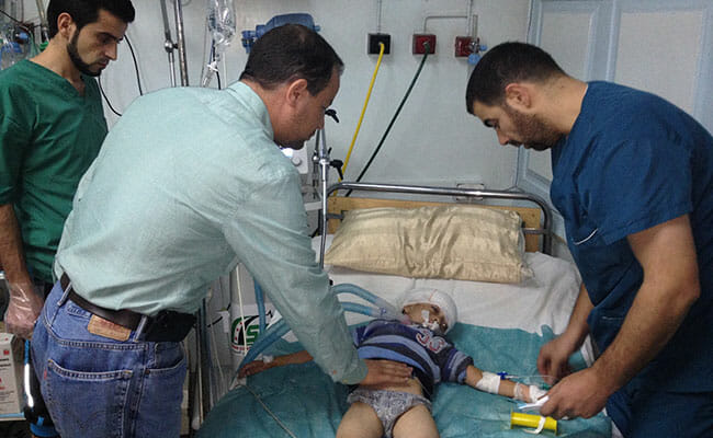 Sahloul taking care of a 3-year-old boy who was shot by a sniper in the “Corridor of Death,” a path connecting east and west Aleppo.