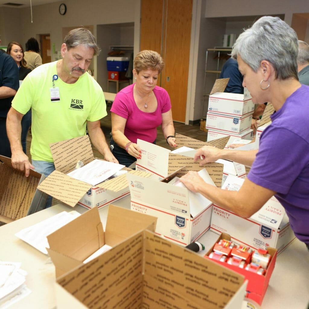 Volunteers in Evandale, Ohio, prepare care packages to be filled.