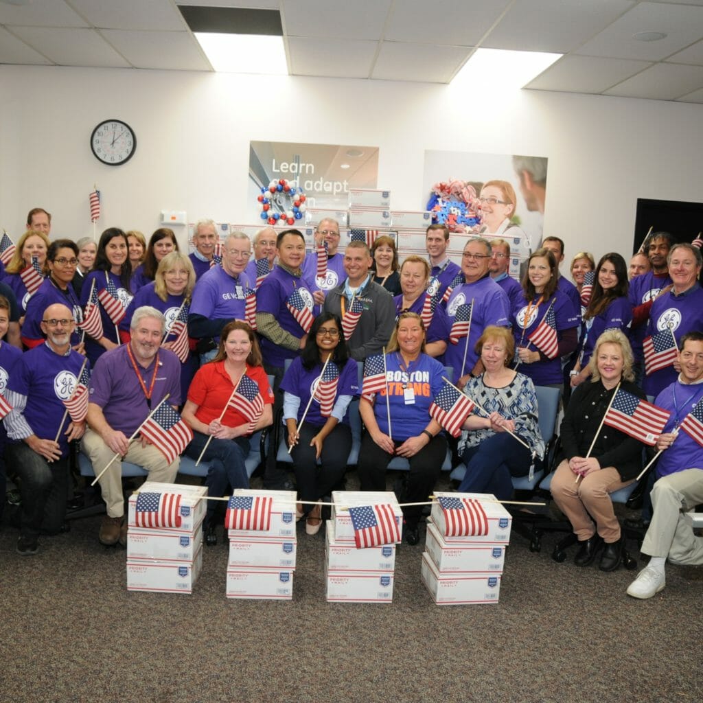 Volunteers in Lynn, Massachusetts, pose with completed care packages.