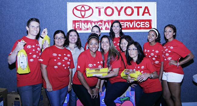 Volunteers from Toyota Financial Services, armed with bread, helped Community's Child set up for its Feed the Children event.