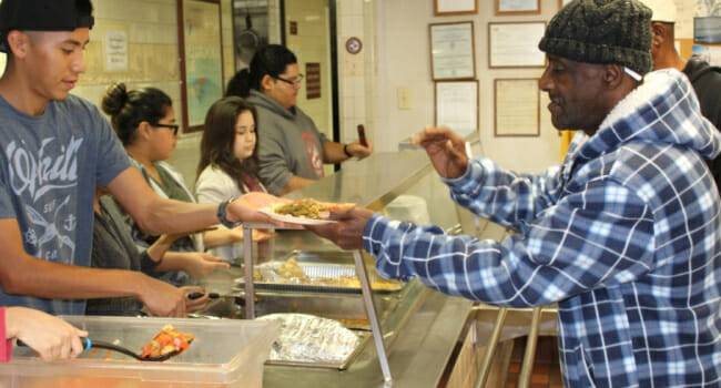 Students from Northbrook High School in Houston joined a Joy Maker event preparing and serving lunch to the 85 residents of Turning Point Center homeless mission. In addition, they created holiday cards and gave them out with donated toiletries. 