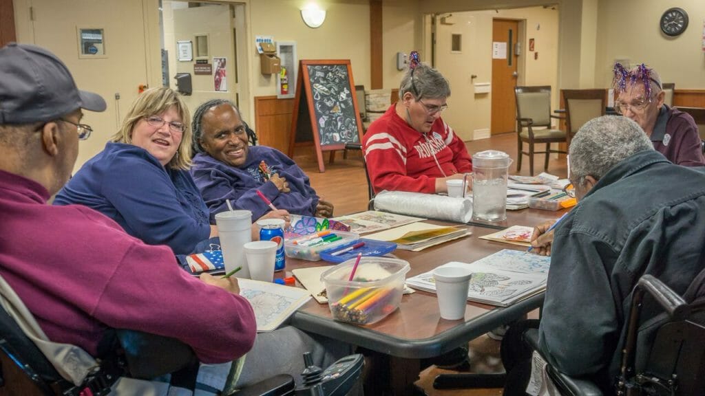 Joy Rich with residents of Maple Crest Care Center coloring and singing along to music./ Courtesy Doug Kuony