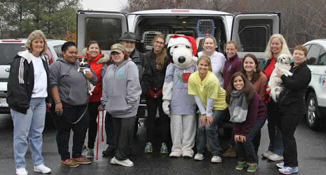 Shaterri Casteel (second from left) and Lucky Dog Animal Rescue volunteers visit the Henry County SPCA in Martinsville, Virginia, to pick up dogs to transport to Washington, D.C., for adoption.