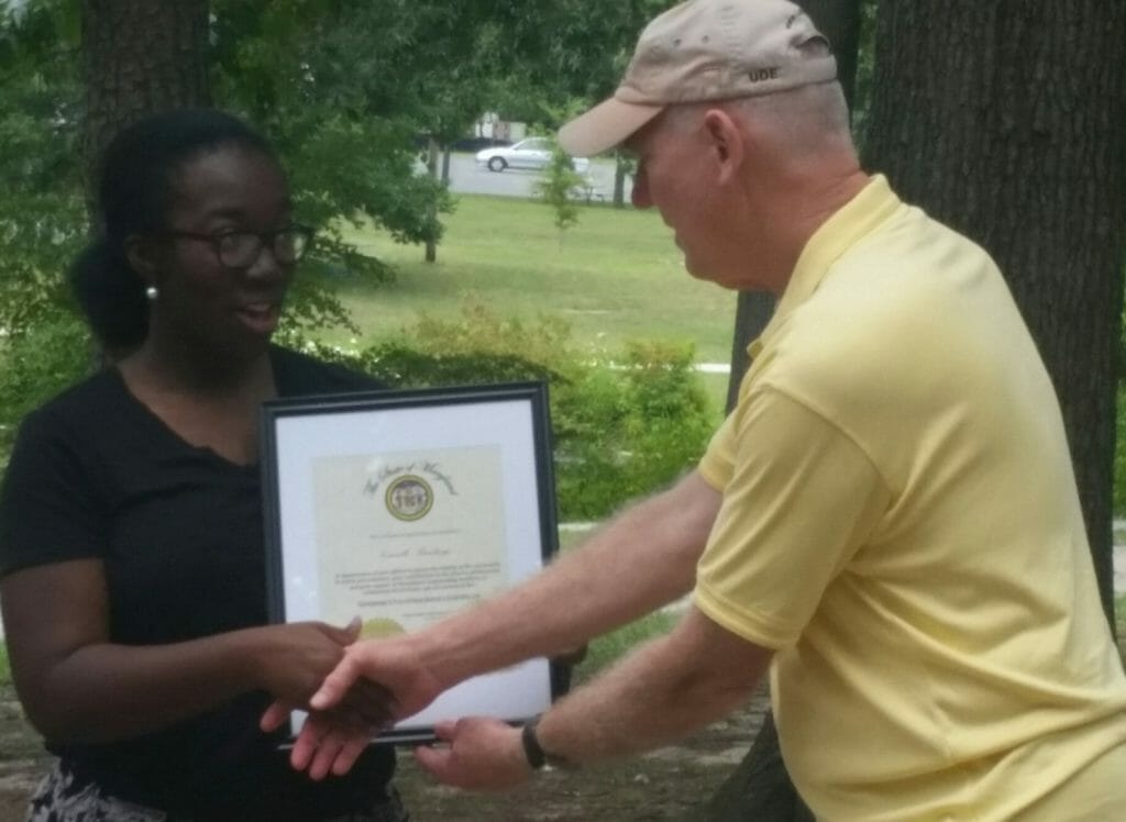 Camille Rawlings receiving the Maryland Governors' Award for Volunteer Service August 2015, which was presented to her by the 352nd Civil Affairs Commander, Brigadier General Alan Stolte.
