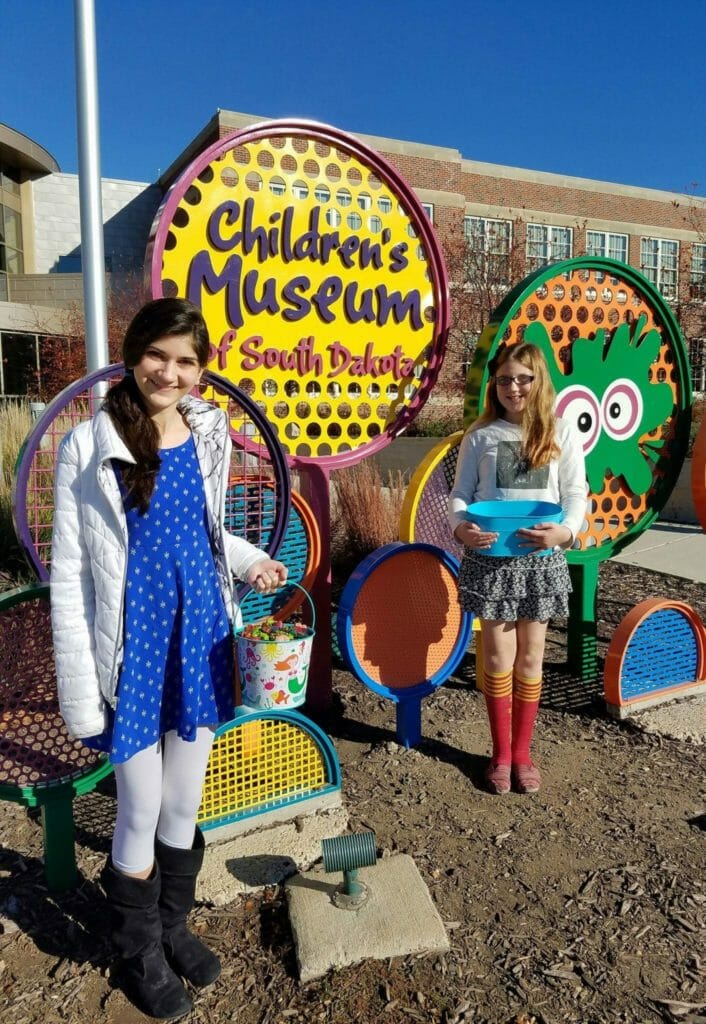 Abby and Riley collect crayons from the Children's Museum of South Dakota.