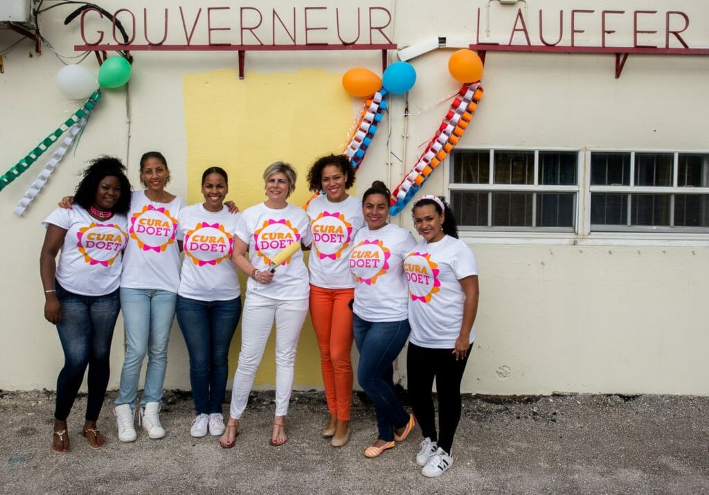 Princess Laurentien (center) joins volunteers for a painting project at a local school. 
