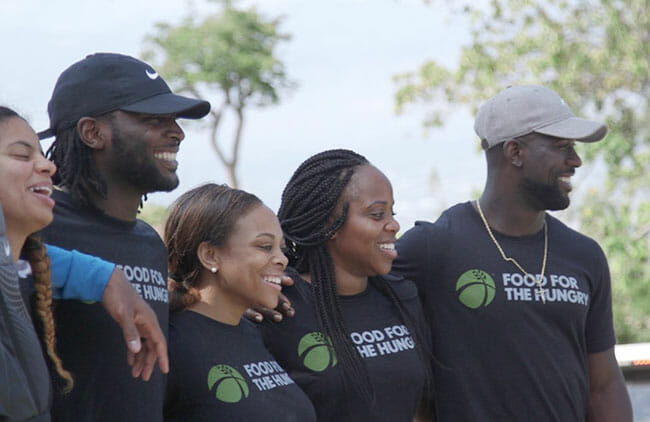 Jonathan Meeks (left) traveled to Haiti with Food for the Hungry, along with fellow NFL player Coty Sensabaugh and Michael Thomas (right).