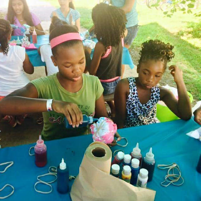 Campers at Operation Heroes Connect's summer camp work on art projects.