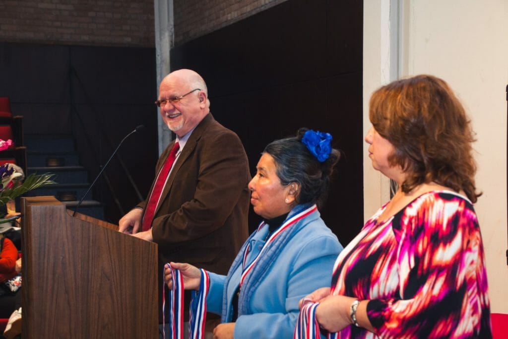 David Godwin speaking at LIFT's 2016 graduation ceremony with student Maria Yupe and the program's assitant to the director, Susana Cuellar.(left to right)/Courtesy David Godwin