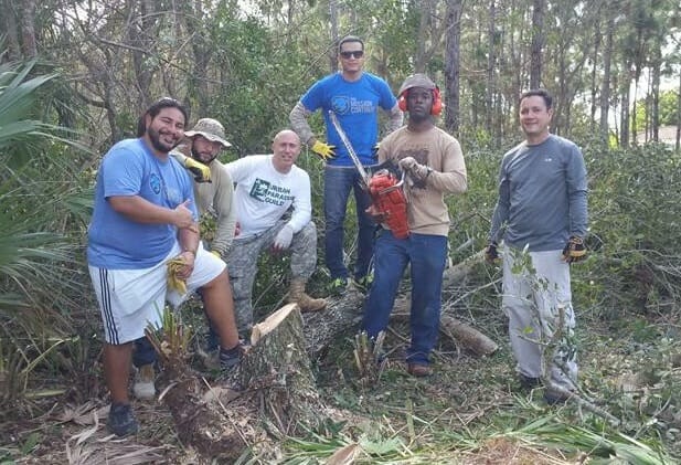 Edwin (left) with volunteers from The Mission Continue's Miami chapter removing invasive species of trees and plants that are threatening the endangered Pine Rockland Habitat./Courtesy Edwin Vasco