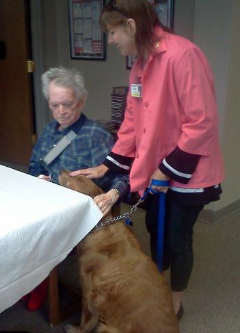 Tamara and Gamsby visit with a patient./Courtesy Tamara O'Hearn-Amman