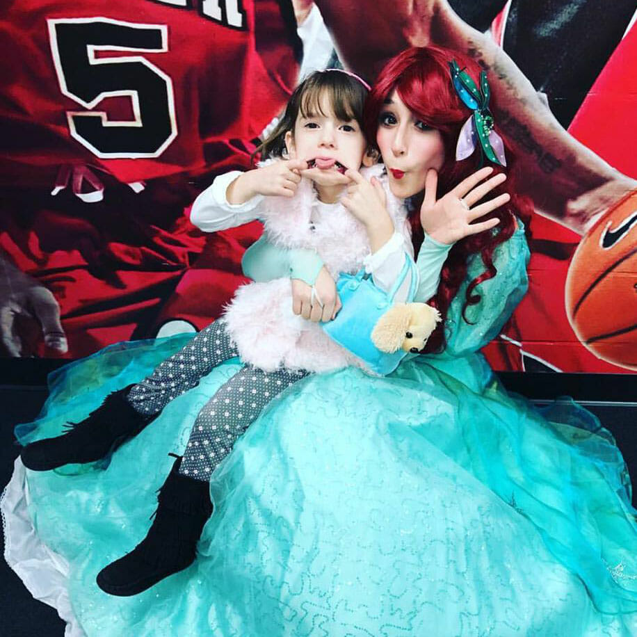 Volunteer Falyn Stein, as Ariel, shows off her best silly face with Avery at an event with Friends of Jaclyn.