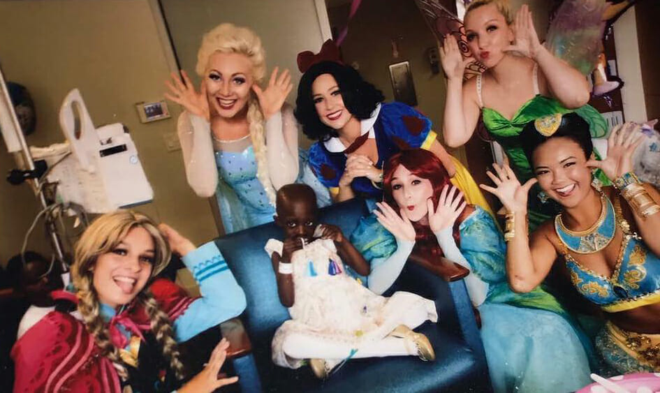 Kylee McGrane, dressed as Princess Elsa from "Frozen," joined by A Moment of Magic volunteer princesses, make a birthday wish come true for 4-year-old Alanna. Pictured from left: Ashley Clayton as Princess Anna; Christina Prendergast as Snow White; Falyn Stein as Ariel; Meghan McLaughlin as Tinkerbell; and Elle Carlin as Jasmine.