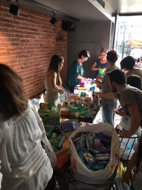 Volunteers with Ethelon pack hygiene kits for refugees.