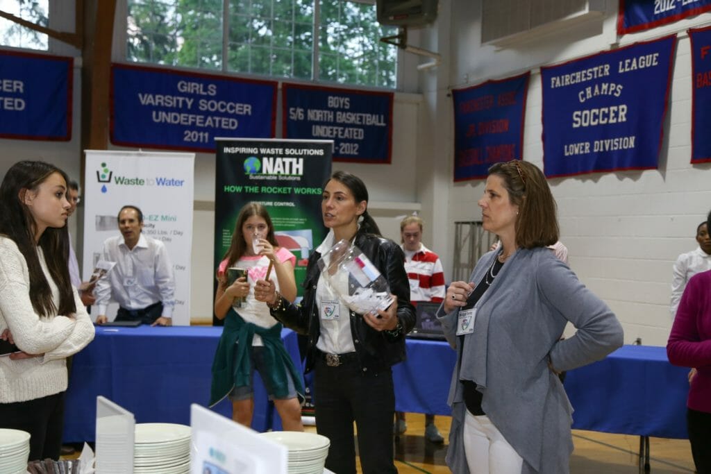 Veronique (center) volunteering at the Beyond Waste: Join the Recovery Revolution in Bedford and Beyond conference./Courtesy Veronique Choa Pittman