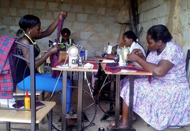 Women assembling MoonCatcher kits at a sewing guild housed in the Women's Resource Center in Jinja, Uganda./Courtesy Ellie von Wellsheim