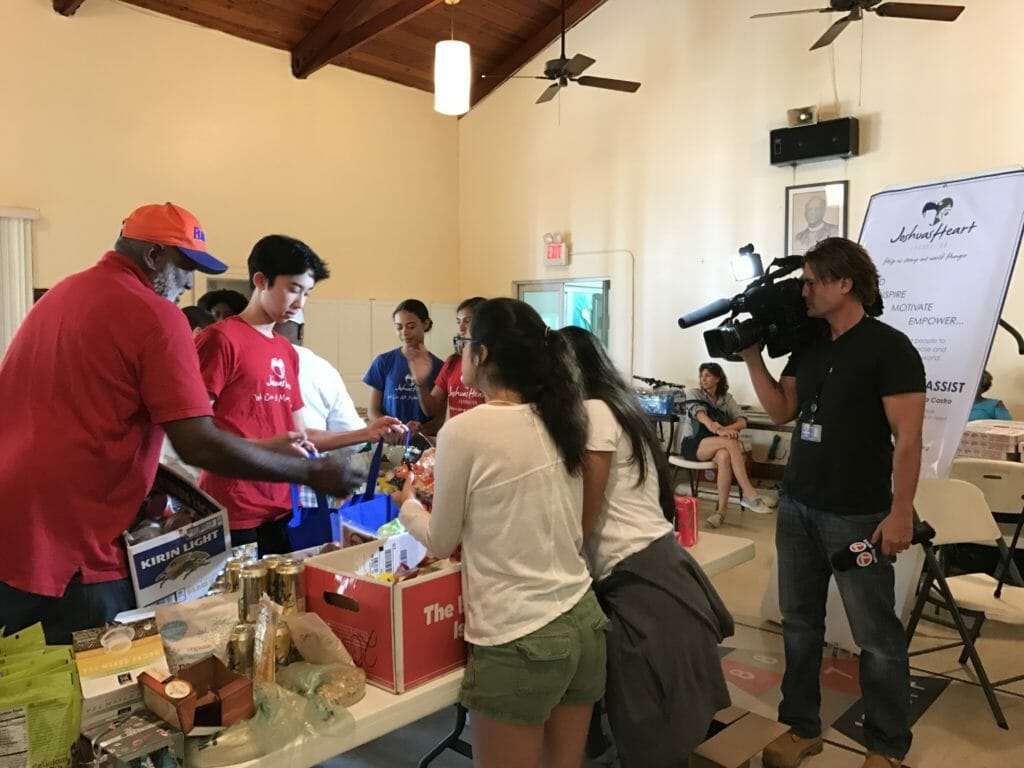 Jordan assisting a shopper while being filmed for a documentary at a grocery distribution at Christ Episcopal Church in Coconut Grove, Fla./Courtesy Miriam Wong