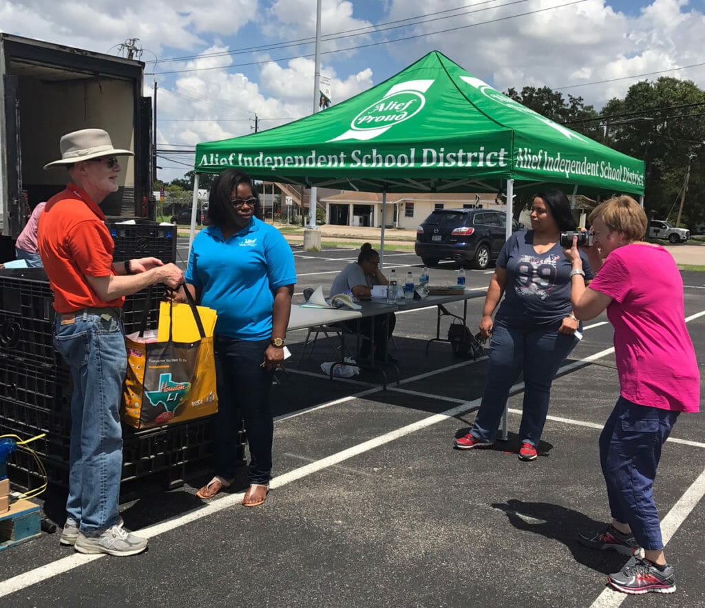 Jill Lefforge (right) shoots photographs at a Houston Food Bank event./Courtesy Jill Lefforge