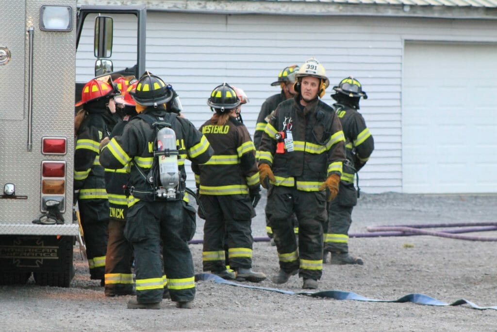 Kevin Flensted (right) performs a car fire drill with the Westerlo Fire Department./Courtesy Kevin Flensted