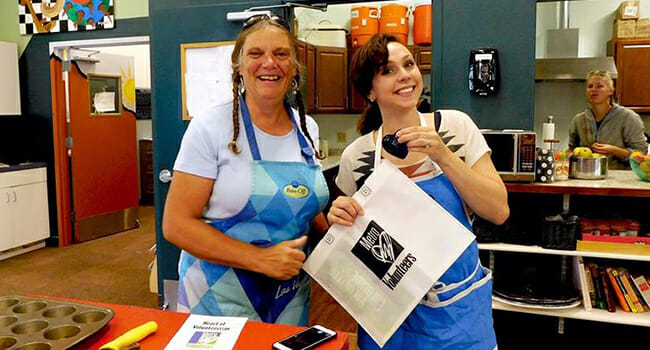 Kim Doyle Wille receives the Metro Volunteer Heart of Volunteerism Award from Drew Schelling, Garfield County coordinator for Cooking Matters, during a cooking class at Yampah Mountain High School.