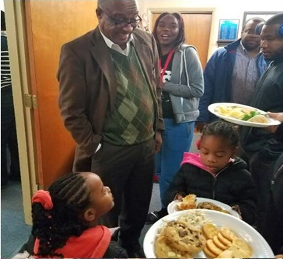 Dr. James Strong (left) greets children of incarcerated families who are being sponsored by CDC during the holidays as part of their annual Angel Tree Program./Courtesy Dr. James Strong