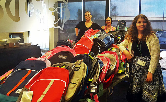 Kaitlyn Martinez, 14-year-old CEO of Backpacks 4 Kids AZ, accepts 200 backpacks donated by GoDaddy employees.