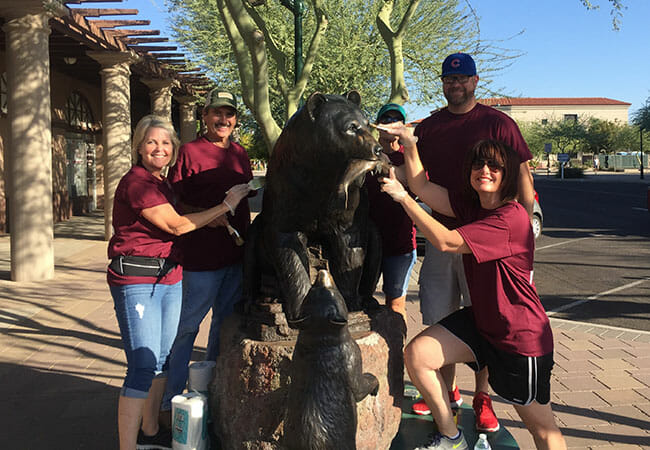 Downtown Mesa Association volunteers and the City of Mesa's executive management team participated in downtown beautification projects, such as waxing statues.