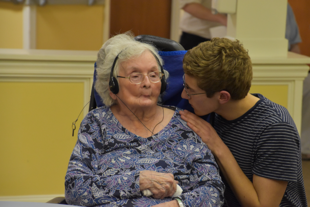 Project Playback co-founder Jason Albaum assists a resident at Kennebunk Center for Health and Rehabilitation./Courtesy Juli Ennis