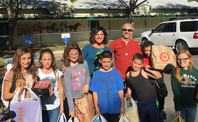Farshad Azad (back row, right) and student participants in the "Gimme Some Sole" shoe drive deliver donations to John McManus Elementary School in Chico, California, after Make A Difference Day 2016. 