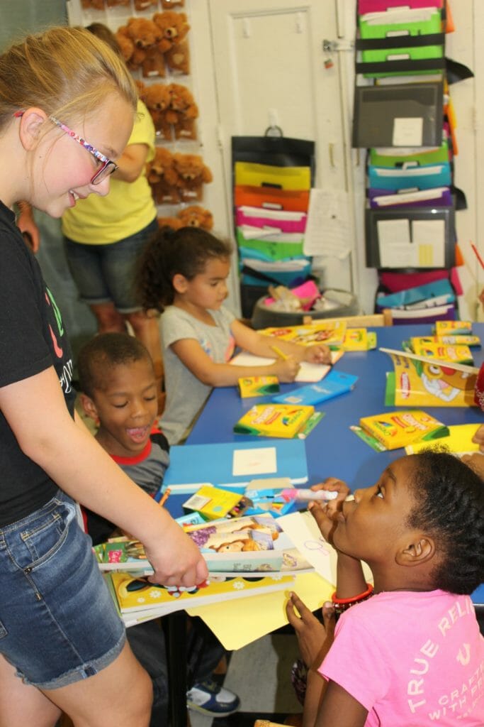 Bethany hands out art supplies to Fairmont Neighborhood School students./Courtesy Bethany Kuster